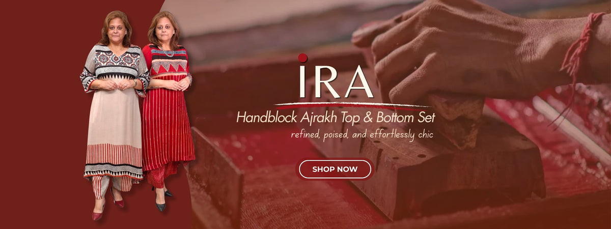 Promotional banner for the IRA Handblock Ajrakh Top & Bottom Set, showing two women modeling patterned traditional outfits alongside a close-up of a hand carving a block. The text reads 'IRA Handblock Ajrakh Top & Bottom Set' with a 'SHOP NOW' button on a warm brown background.