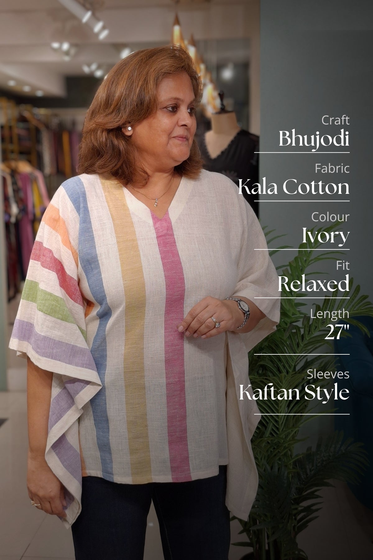 A woman modeling a relaxed-fit, V-neck Kala cotton tunic top in ivory with vertical pastel stripes in pink, yellow, green, blue, and purple. The image includes text overlays detailing the product's specifications on the right side.
